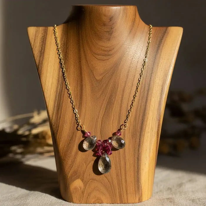 Adjustable Gold Filled Wire Wrapped Gemstone Necklace featuring mystic rainbow quartz and fuchsia crystals on a display.