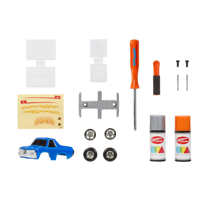 Collection of model car building tools and supplies on a white background