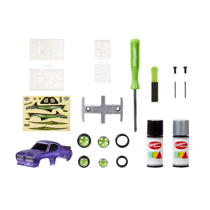 Collection of model car accessories including a purple car base, wheels, tools, and paint cans on a white background