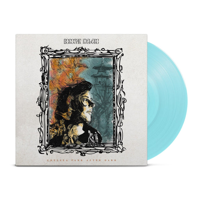 White vinyl jacket with a drawing of a picture frame in the middle. Inside the frame, there is a person looking to the side. Inside the frame, the background colors are half yellow and half blue. Above the frame, there is text that says DONOVAN MELERO. Below the frame, there is small text that says CHELSEA PARK AFTER DARK. Peeking out of the side of the jacket is a baby blue vinyl.