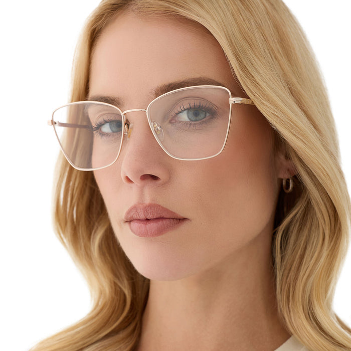 on model - female wearing diff eyewear featuring the connie cat eye prescription glasses with a gold frame angled view