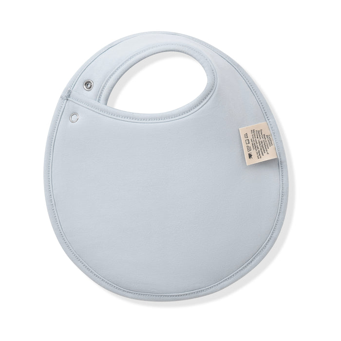The back of the Cushy Bib in Mallard Duck showing the light blue backing