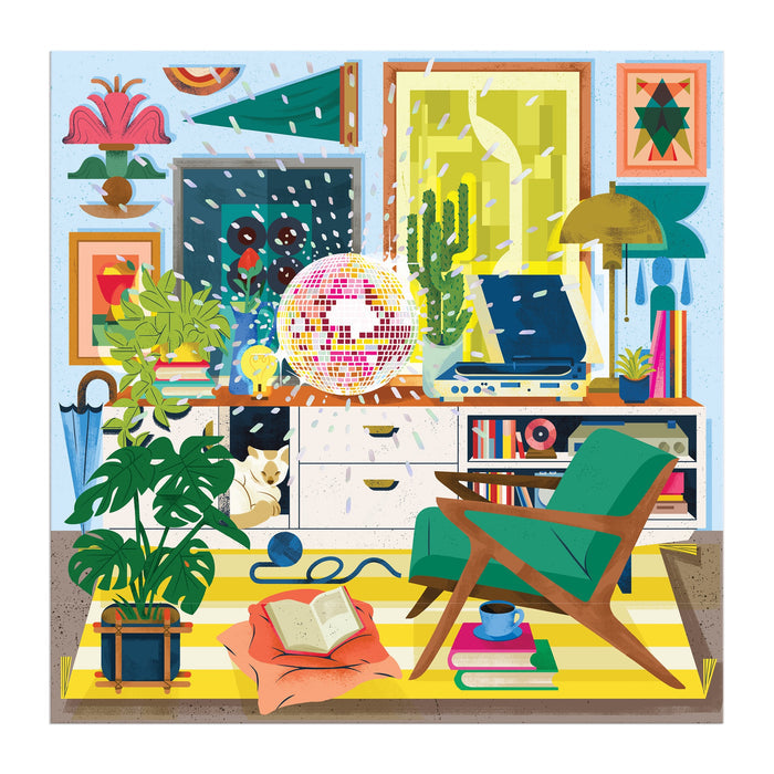 Cozy and colorful, the Disco Life 500 Piece Foil Puzzle by EurekartStudio features houseplants, a green armchair, retro vibes, a sleeping cat, glowing disco ball, wall art, books and mug on the floor—all set against falling snow outside.