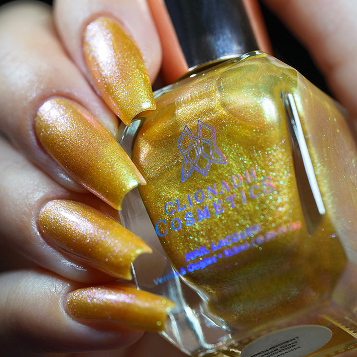 Close up shot of nails done with Embellishment nail lacquer on fair skin tone holding the nail lacquer bottle