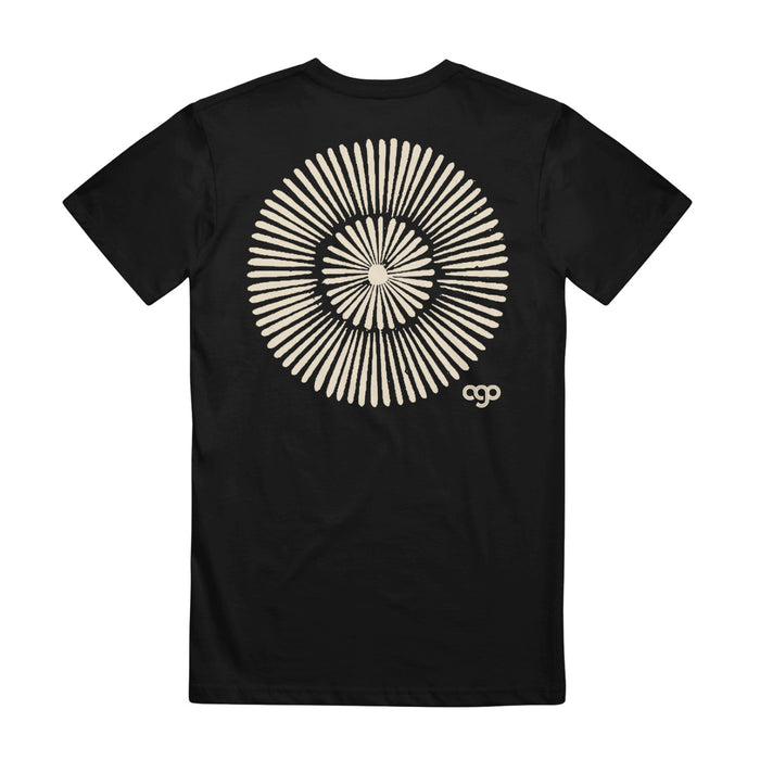 Black t shirt against white background. Back of shirt has a larger version of the same circle symbol in the center, and "AGO" printed in right corner.