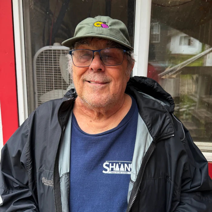 Greg wearing a geoduck dad hat
