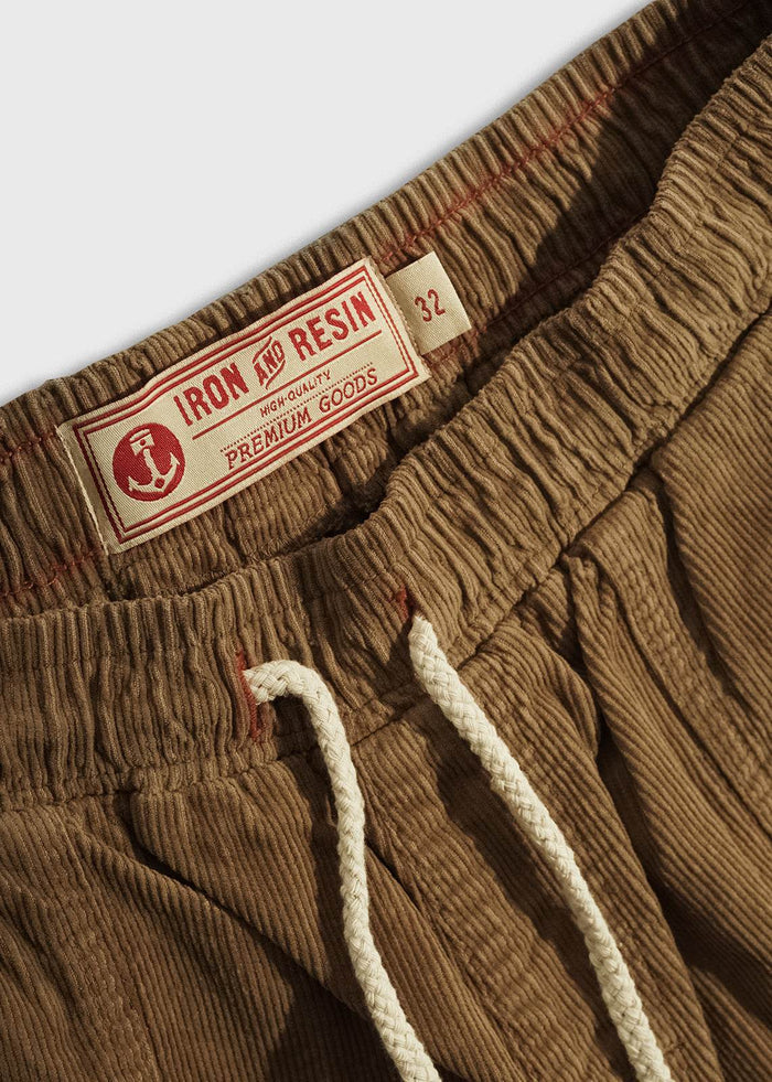 Close-up of men’s 14 wale corduroy shorts elastic waistband, draw string, custom tag and durable workwear inspired short