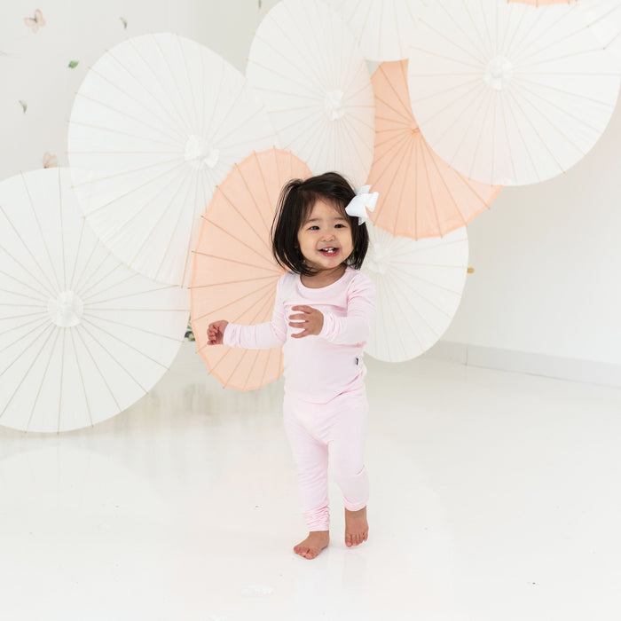 Toddler wearing Kyte Baby bamboo Long Sleeve Pajamas in Sakura
