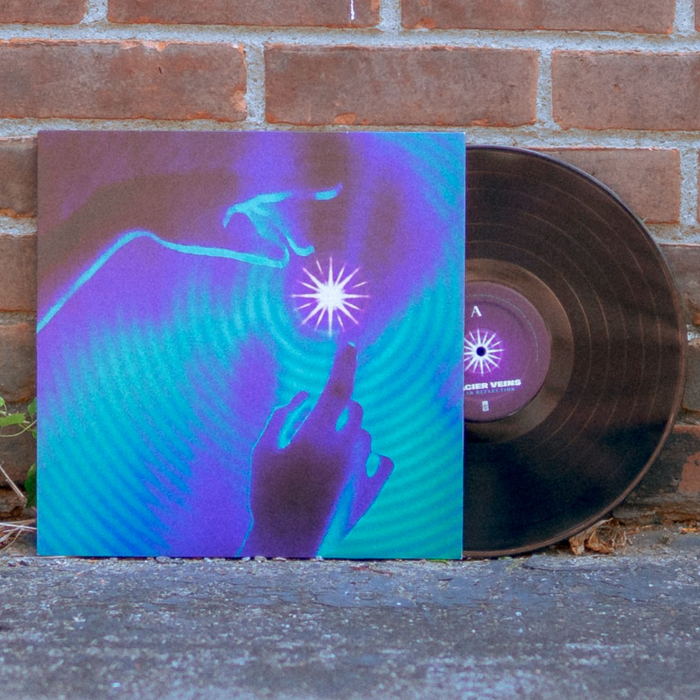 Vinyl jacket with a drawing of two hands reaching for a star. Around the star and covering the whole album cover is a ripple effect drawn in purple and green. Peeking out of the vinyl jacket is a black vinyl