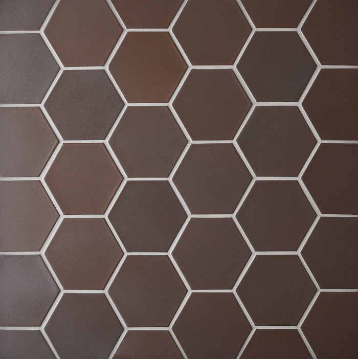 Caption: Classic Field 3.5" Hex in M39.2 Matte Brown. Prism Truffle grout by Custom Building Products.