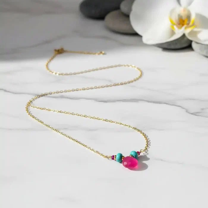 Gold Filled Turquoise and Pink Gemstone Drop Necklace with vibrant pink chalcedony and turquoise on a marble background.