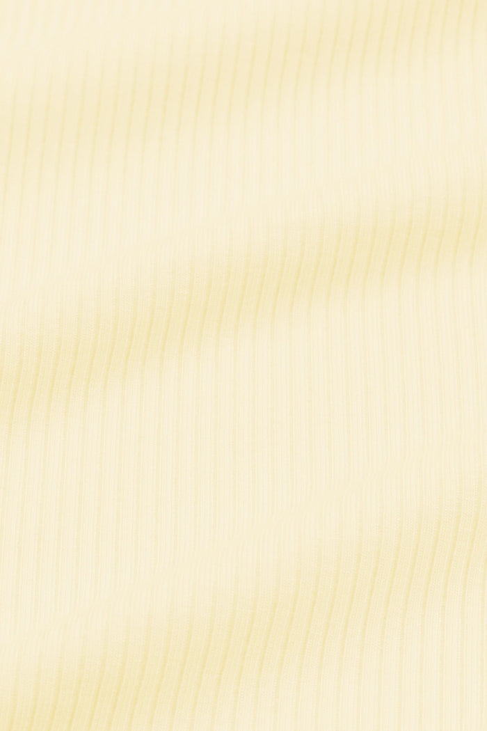 Close up of the ribbed fabric: A muted pastel yellow