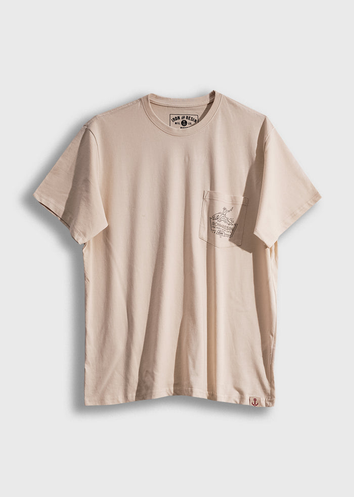 Beige T-shirt with a small pocket featuring a printed design. The shirt is displayed against a plain white background.