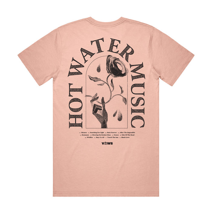 Photo of the back of the shirt. The back of the shirt has the band name "HOT WATER MUSIC" arched around a hand holding a rose. There is also very small text underneath the main design that is unreadable in the photo.