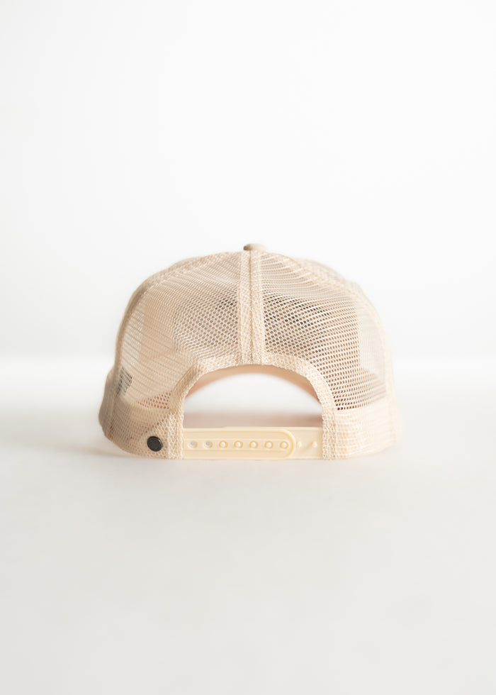 Beige mesh trucker hat viewed from the back, showcasing adjustable snap closure against a plain white background.