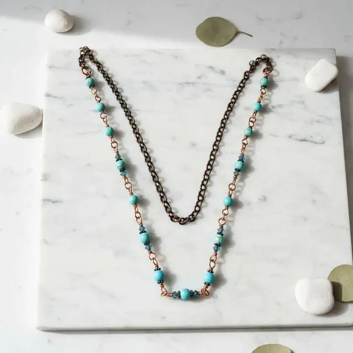 Wire Wrapped 24 Inches Copper Turquoise Necklace displayed on a marble surface with turquoise and copper beads.