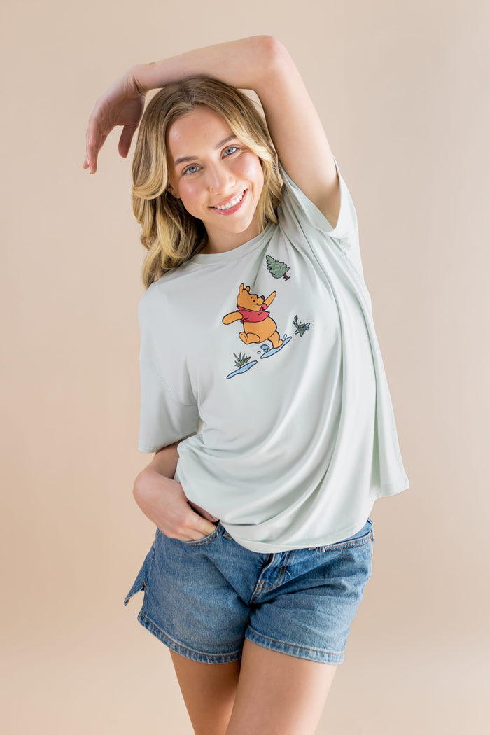 Female model posing wearing the Women's Graphic Tee in Winnie the Pooh on Dew
