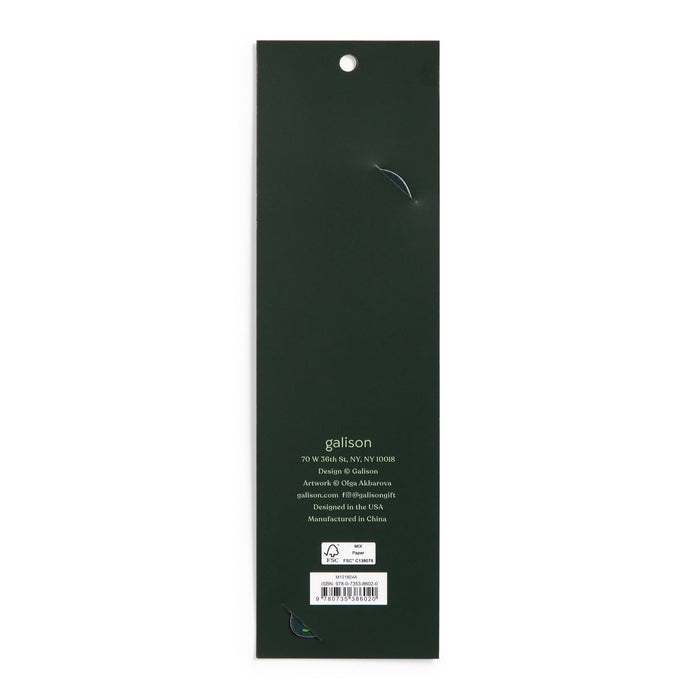 The image shows the back of a long, dark green rectangular package for the World of Mushrooms Paper Bookmark by Olga Akbarova, with a hanging hole at the top. Branding, contact info, and a barcode are near the bottom. Two small tears are visible.
