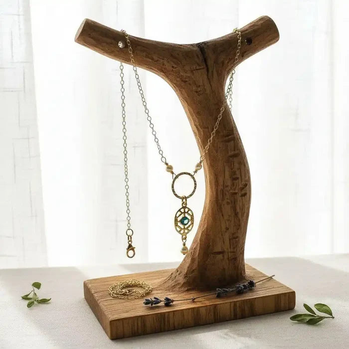 14 K Gold-Filled Hammered Open Circle Filigree Necklace displayed on a wooden jewelry stand with natural light.