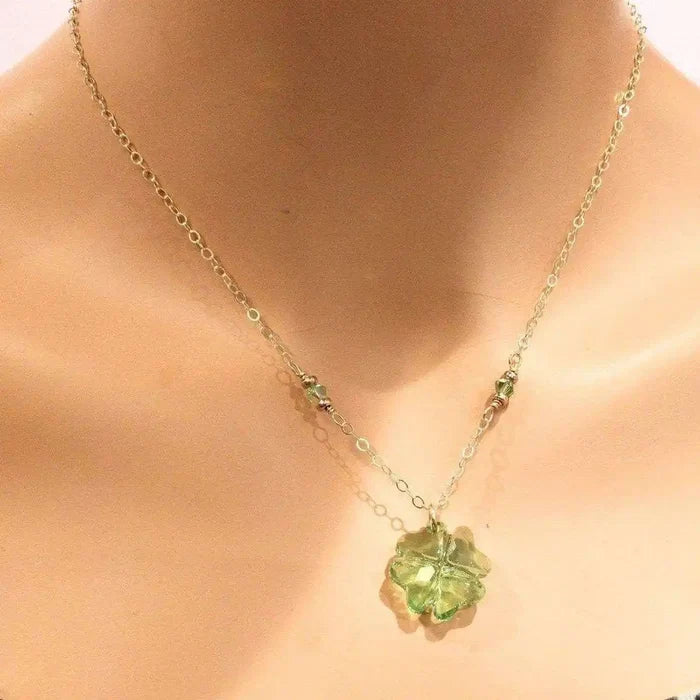 14 K Gold Filled Light Green Crystal Clover Necklace displayed on a mannequin, showcasing its elegant design and Peridot-colored Swarovski Crystal.