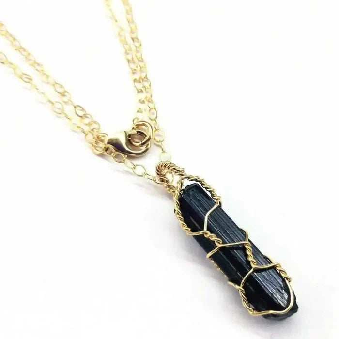14 K Gold Filled Wire Wrapped Raw Black Tourmaline Necklace featuring a raw black tourmaline stone delicately wrapped in gold.