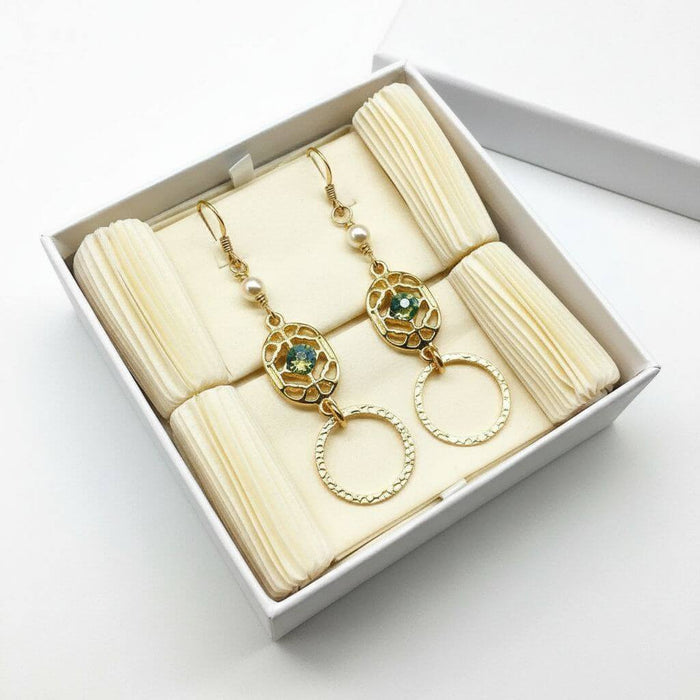 14 KT Gold Filled Green Crystal Circle Filigree Earrings displayed in a gift box with cream-colored padding.