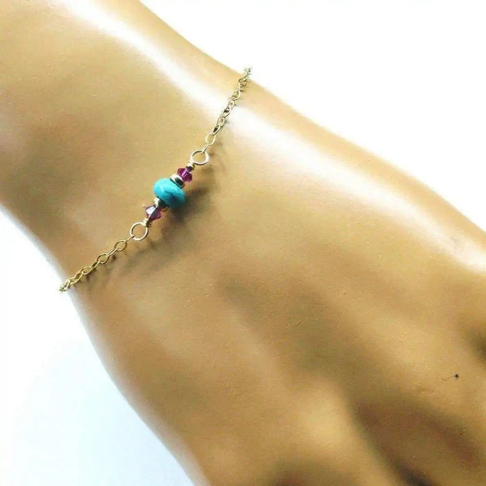 14K Gold Filled Pink and Turquoise Gemstone Dainty Bracelet worn on a hand showcasing its elegant design.