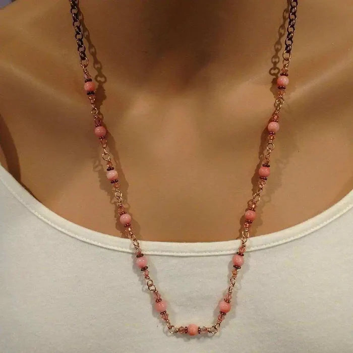 24-Inch Copper Peach Pearl Crystal Wire Wrapped Necklace displayed on a mannequin, featuring peach pearls and antiqued copper.