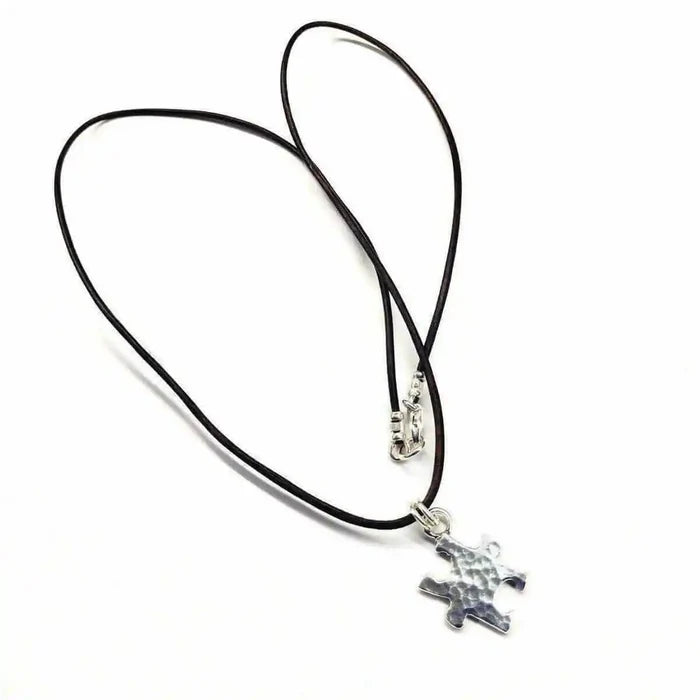 925 Silver Autism Awareness Puzzle Piece Leather Necklace with a hammered texture pendant on a leather cord.