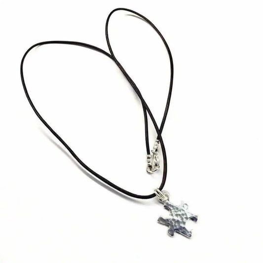 925 Silver Autism Awareness Puzzle Piece Leather Necklace with a hammered texture pendant on a leather cord.
