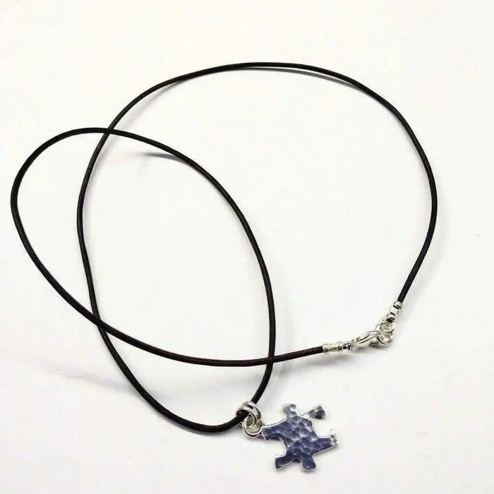 925 Silver Autism Awareness Puzzle Piece Leather Necklace featuring a rustic puzzle piece pendant on a leather cord.