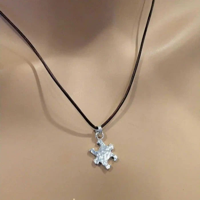 925 Silver Autism Awareness Puzzle Piece Leather Necklace displayed on a mannequin, highlighting the textured pendant.