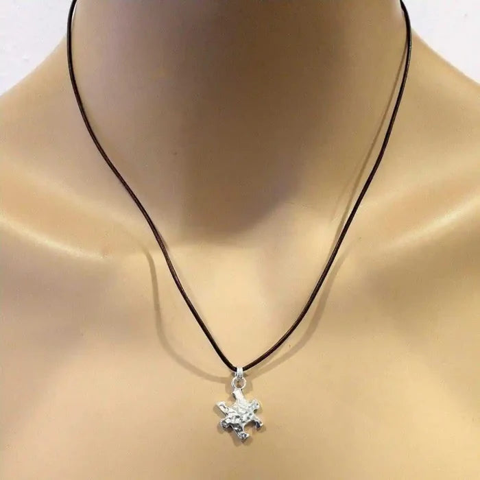 925 Silver Autism Awareness Puzzle Piece Leather Necklace on display mannequin