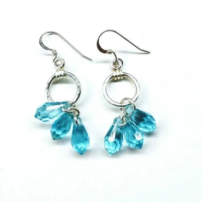 925 Silver Hammered Aqua Crystal Cascading Drop Earrings featuring hand-hammered silver and aqua Swarovski crystals.