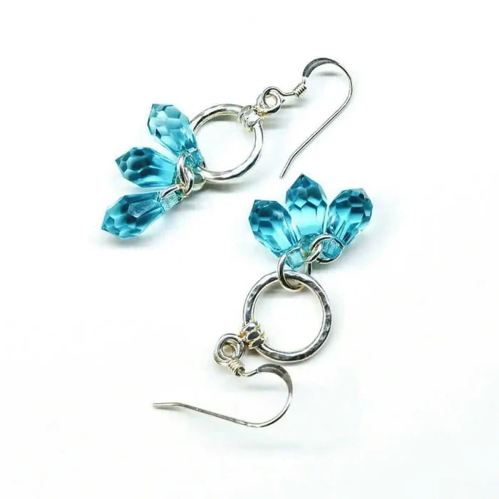 925 Silver Hammered Aqua Crystal Cascading Drop Earrings featuring aqua Swarovski crystals and silver components.