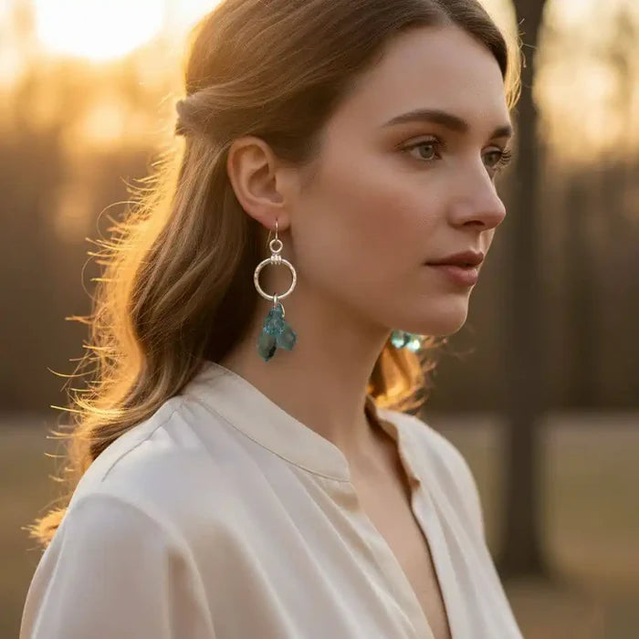 Model wearing 925 Silver Hammered Aqua Crystal Cascading Drop Earrings in natural light with a soft background.