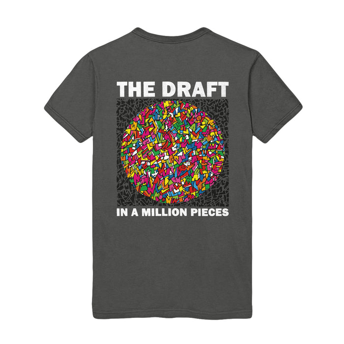 Photo of the front of the shirt, The shirt has a circular design. The Pattern is of colorful shards of stained glass.  The text "THE DRAFT" is on the top. The text on the bottom reads "IN A MILLION PIECES".