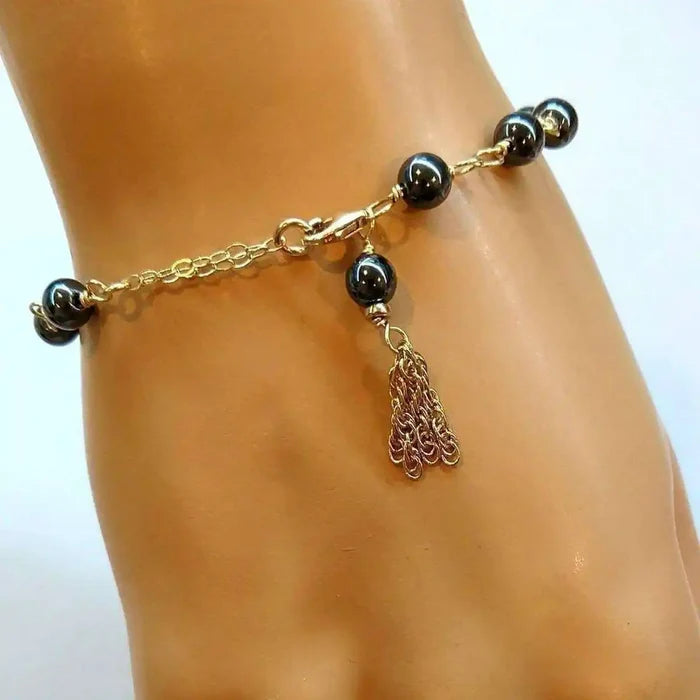 Adjustable 14 KT Gold Filled Hematite Chain Tassel Bracelet showcasing a gold chain and hematite beads with tassel.