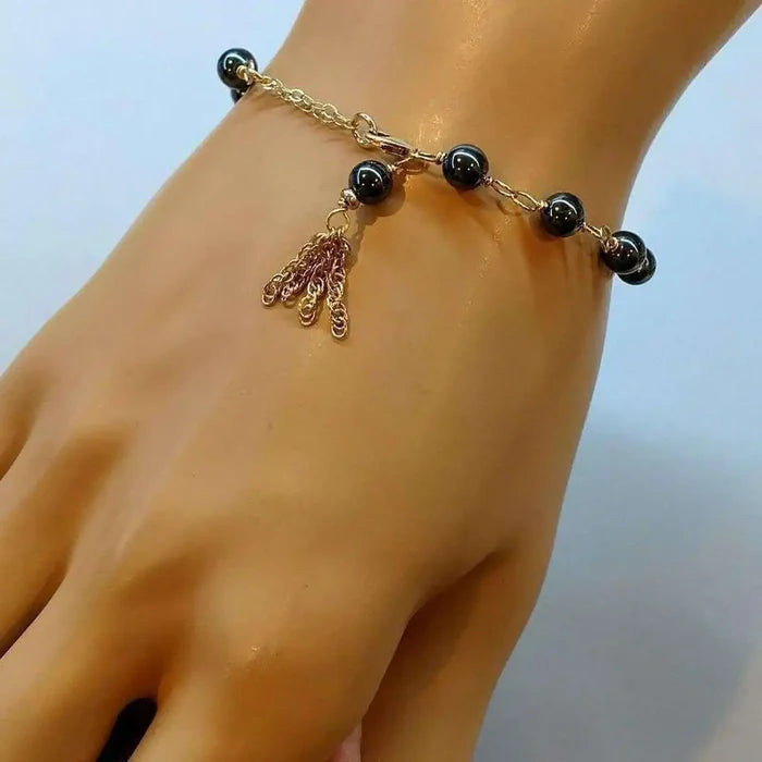 Adjustable 14 KT Gold Filled Hematite Chain Tassel Bracelet displayed on a hand, showcasing its elegance and design.