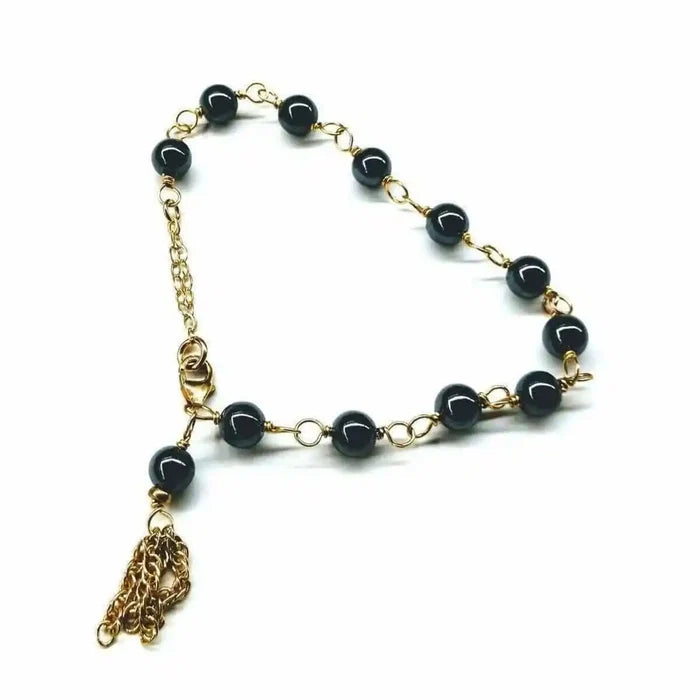 Adjustable 14 KT Gold Filled Hematite Chain Tassel Bracelet featuring gold chain and shimmering hematite beads.