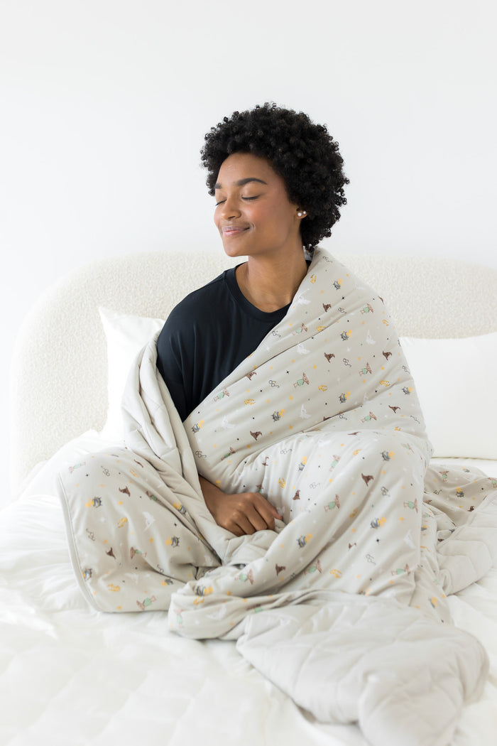 Person wrapped in a Harry Potter patterned blanket on a white bed