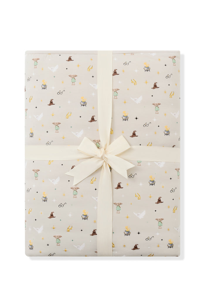 Packed Beige Adult Blanket in Harry Potter pattern print with a ribbon on a white background