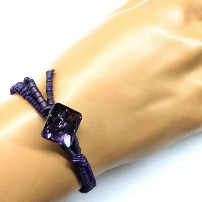 Amethyst Braided Leather Swarovski Crystal Button Bracelet worn on wrist, showcasing elegant braided detail and crystal centerpiece.
