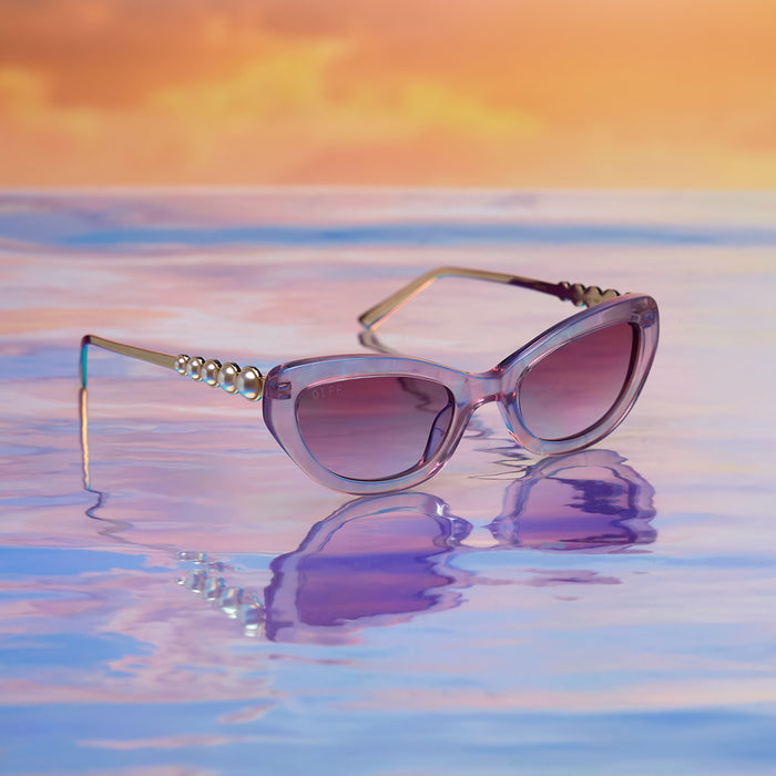 still life - diff eyewear x disney princess featuring the ariel 3.0 cateye sunglasses with a pink acetate frame and wine gradient lenses angled view on water
