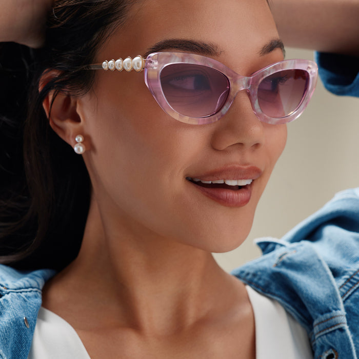 lifestyle - female wearing diff eyewear x disney princess featuring the ariel 3.0 cateye sunglasses with a pink acetate frame and wine gradient lenses detailed view