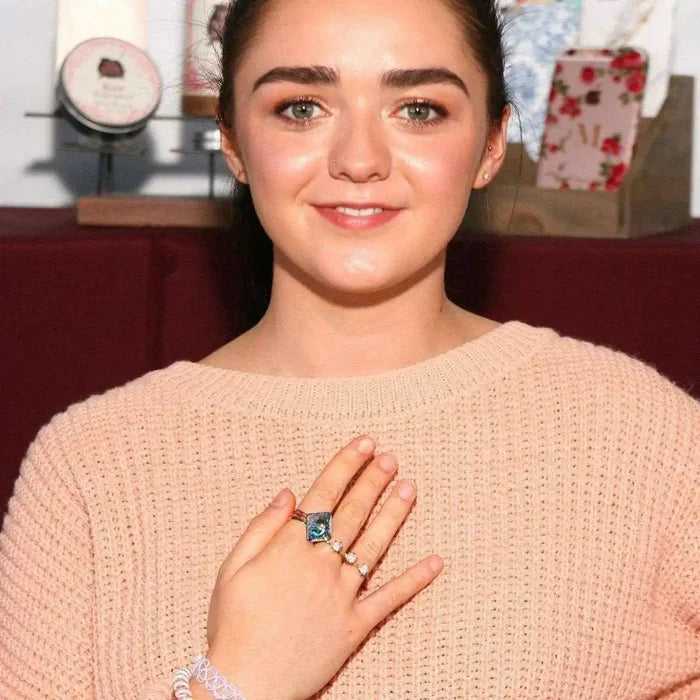 As Seen on Maisie William Super Sparkly Crystal Bling Ring worn by a smiling woman in a cozy sweater.