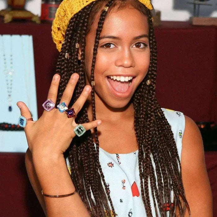As Seen on Maisie William Super Sparkly Crystal Bling Ring worn by a girl with braided hair and colorful clothing.