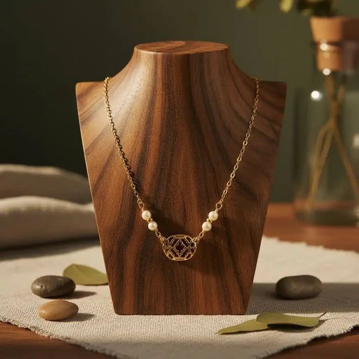 As Seen on Molly Ringwald Gold Filled Pearl Choker Necklace displayed on a wooden bust with soft background.