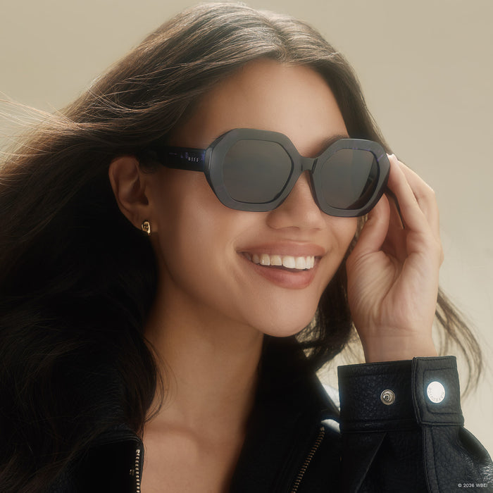 on model - female wearing diff eyewear x practical magic 2 aunt jet round sunglasses with a purple tortoise frame and brown lenses angled view