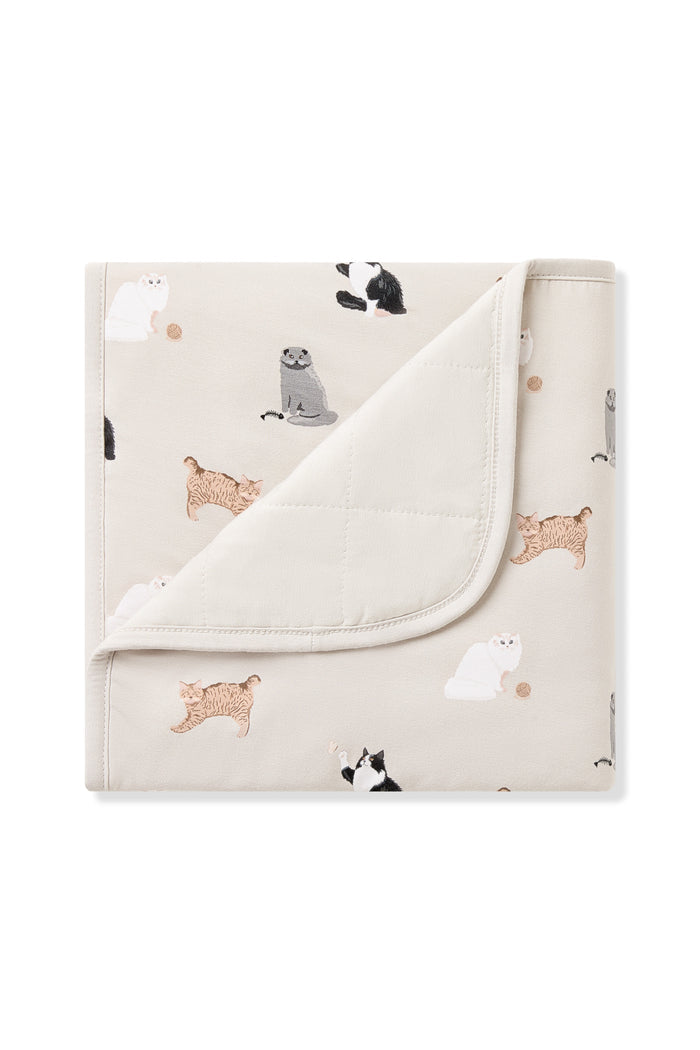 Baby Blanket in Fluffy Cat with the corner flipped down showing the light beige quilted backing